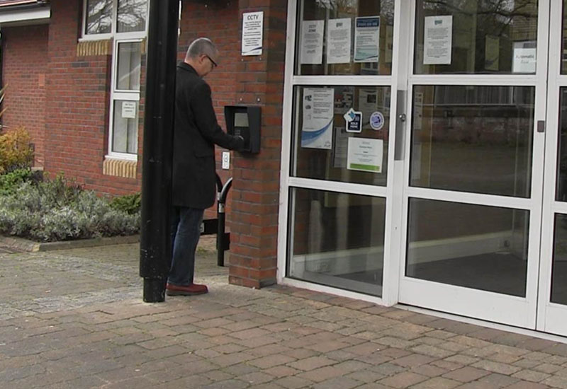 Library user entering South Gloucestershires library using open+