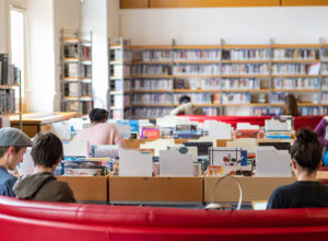 A number of people sat reading in Universite Jean Moulin Lyon