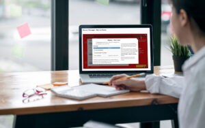 Library staff member using Bibliotheca Academy training platform on a laptop