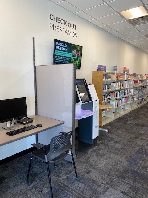 Self-service checkout kiosk and digital screen inside Jefferson County Public Library Express Library