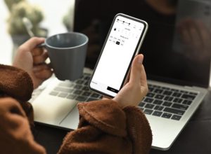 Frau reserviert einen Bibliotheksbesuch auf Ihrem Smartphone