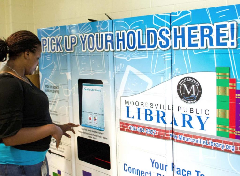 Lady using the remotelocker at Mooresville library