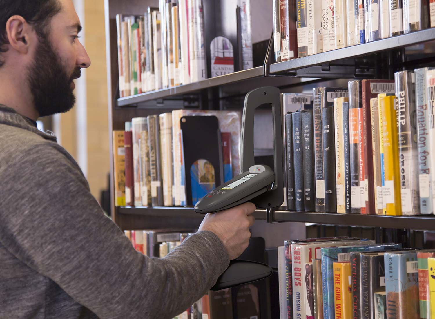 Man taking library inventory with RFID wand