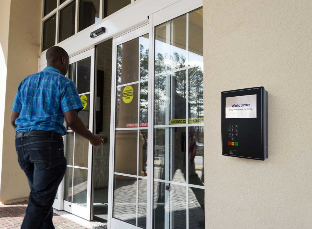 Man walking into library after gaining access using open+ access