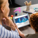 Mother and daughter reading ebook on tablet