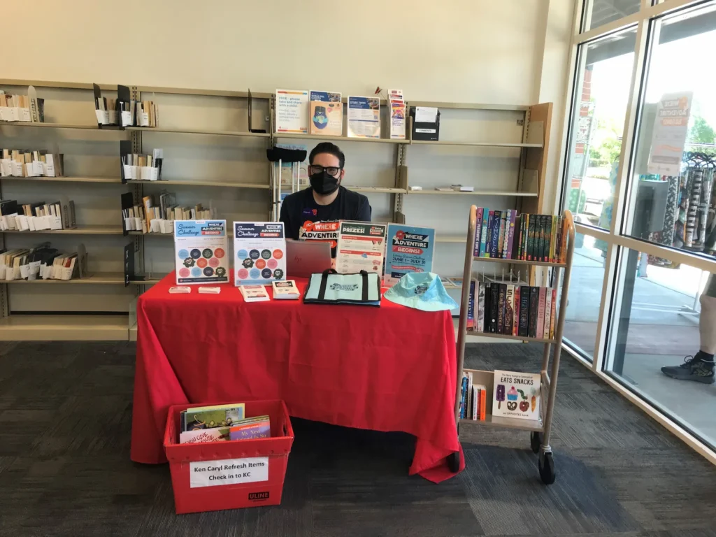 Summer Challenge kickoff table inside Jefferson County Public Library Express Library with program materials and activities