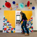 A student retrieves books from the Jean remoteLocker system at Augsburg University Library, highlighting flexible, self-service access for students.