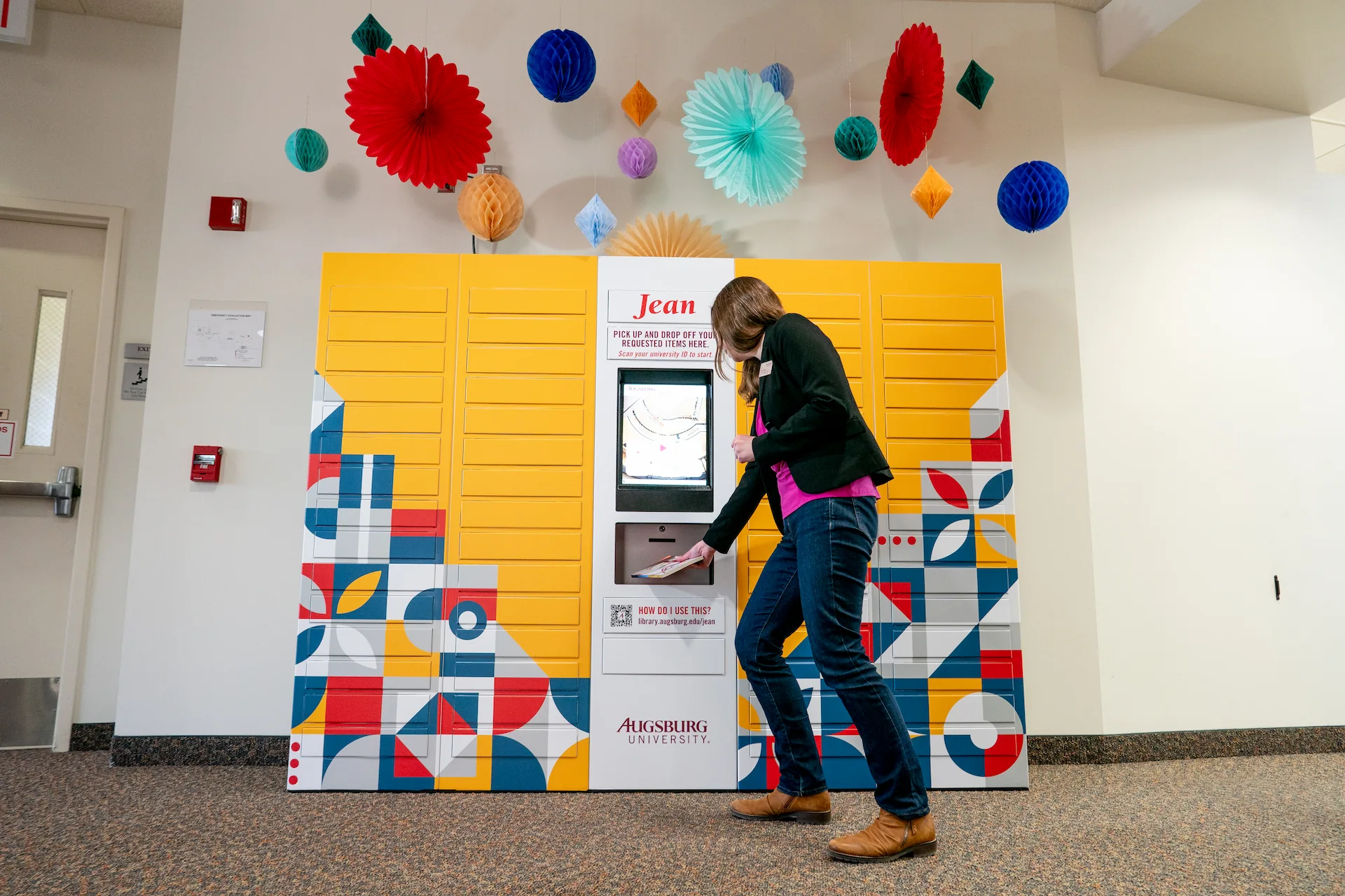 The National Education Summit - Melbourne 2 A student retrieves books from the Jean remoteLocker system at Augsburg University Library, highlighting flexible, self-service access for students.