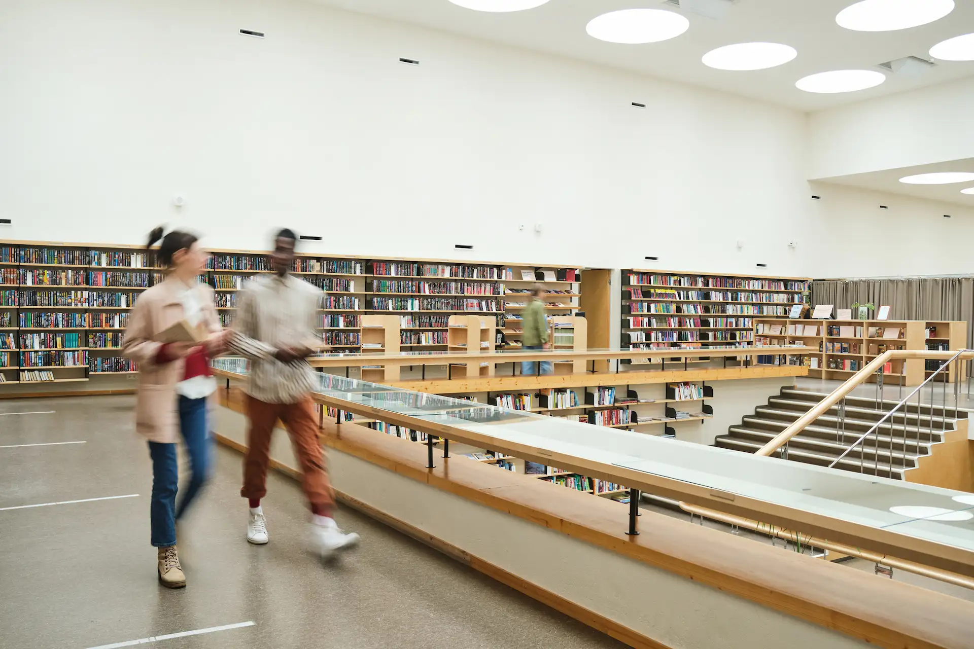 In Mesa, a Library With No Staff—and No Shortage of Visitors 5 Modern public library interior with visitors walking through a bright reading area
