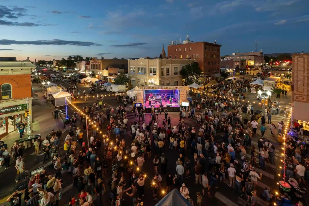 Crowds attending an evening community event in downtown Laramie, Wyoming