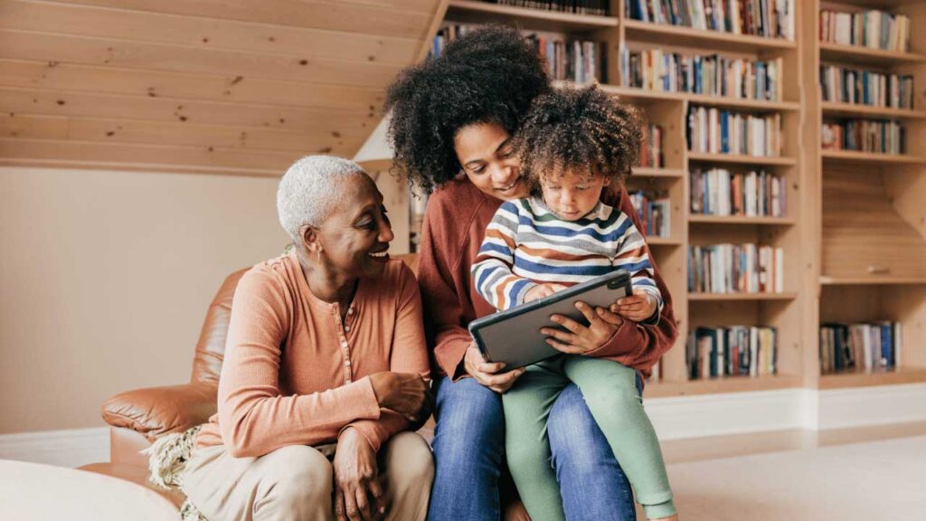 family reading a tablet device