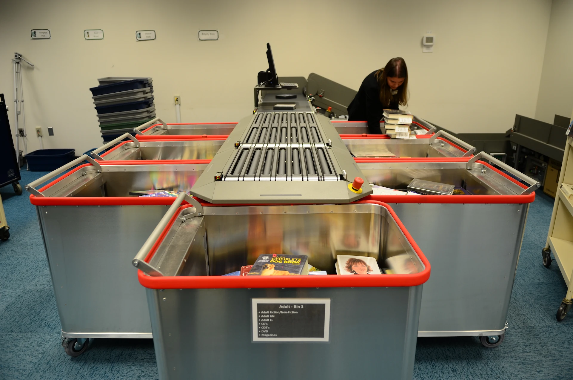Meet the new DLA inventoryWand 2 Bibliotheca flex AMH automated materials handling system sorting returned library items into bins at Forsyth County Public Library.