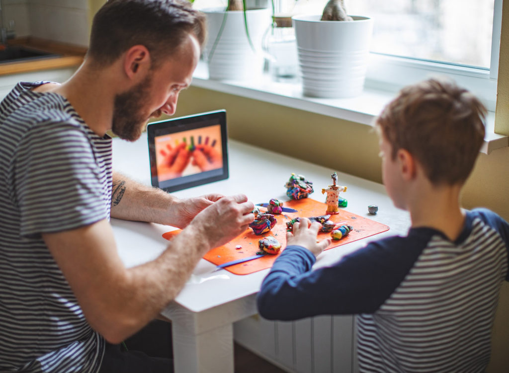 Father and son following online video to do crafts