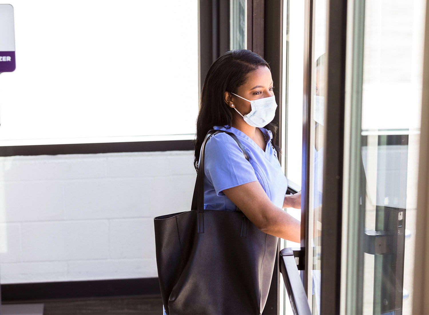 nurse walking out of building