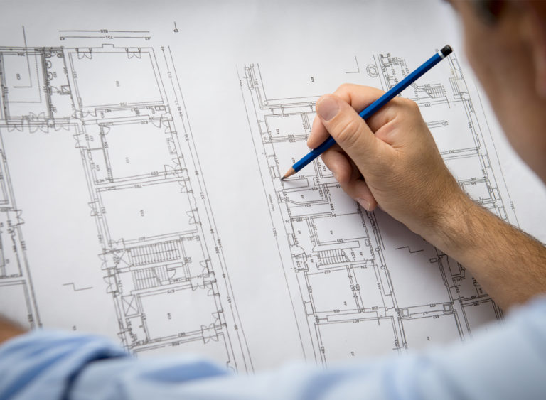 Man working on architect drawing