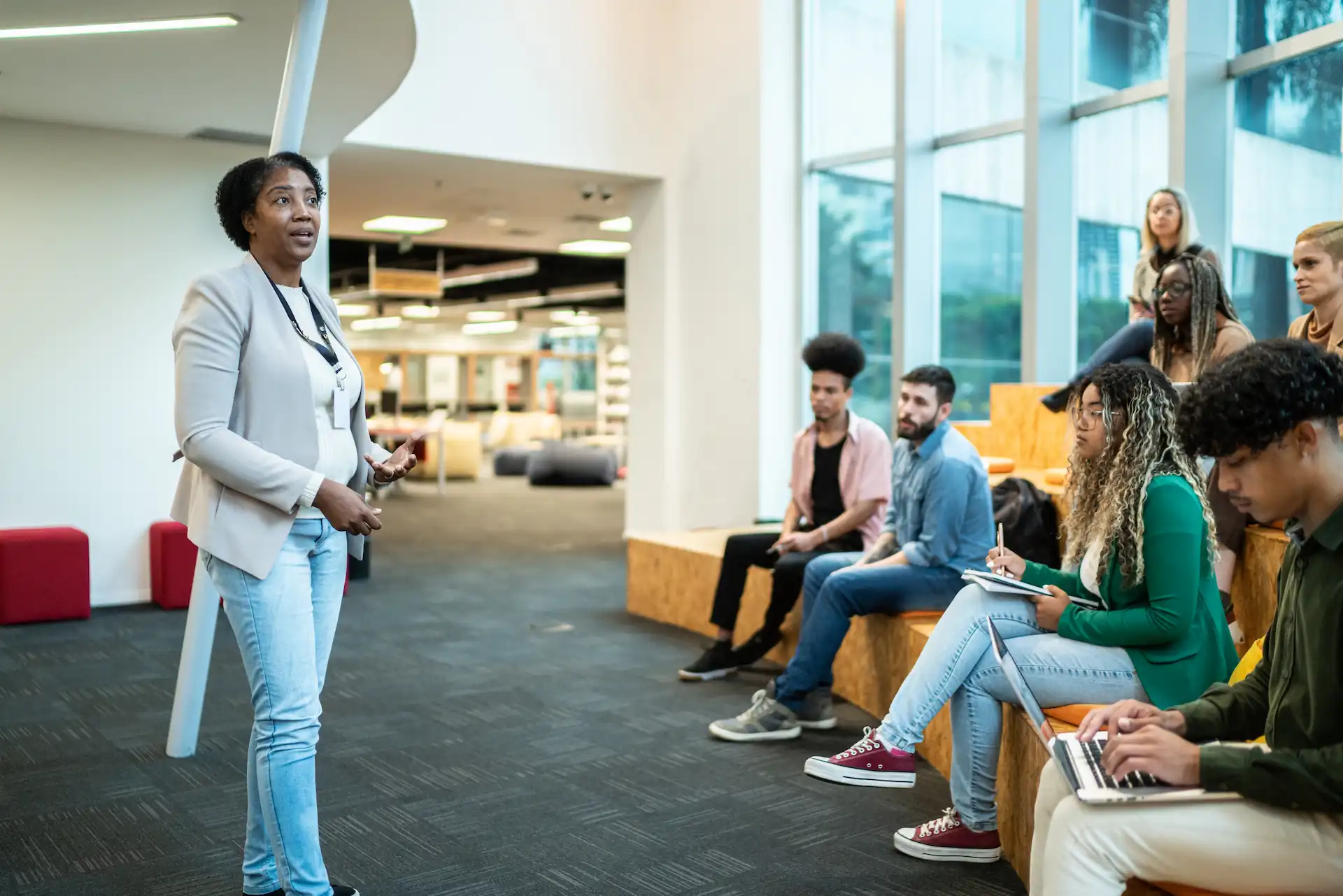 Webinar: Accessibility in Action – Building Inclusive Library Experiences 4 Library patrons attending a community program in a modern public library.