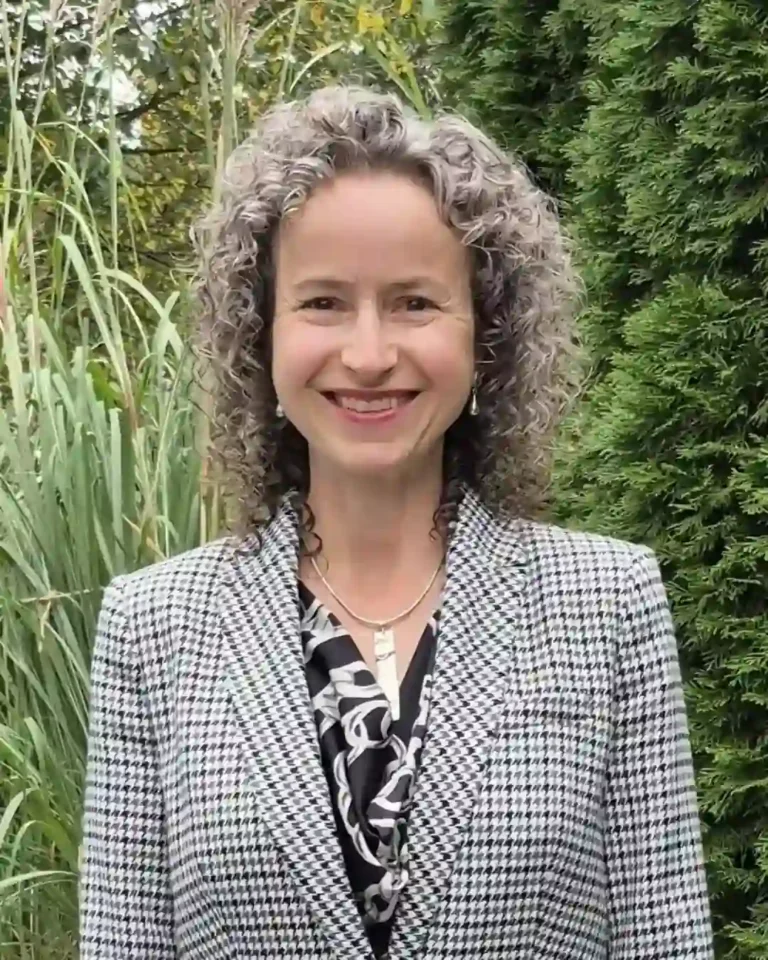 Lisa Stamm, senior solution consultant at Bibliotheca, smiling outdoors in a houndstooth blazer