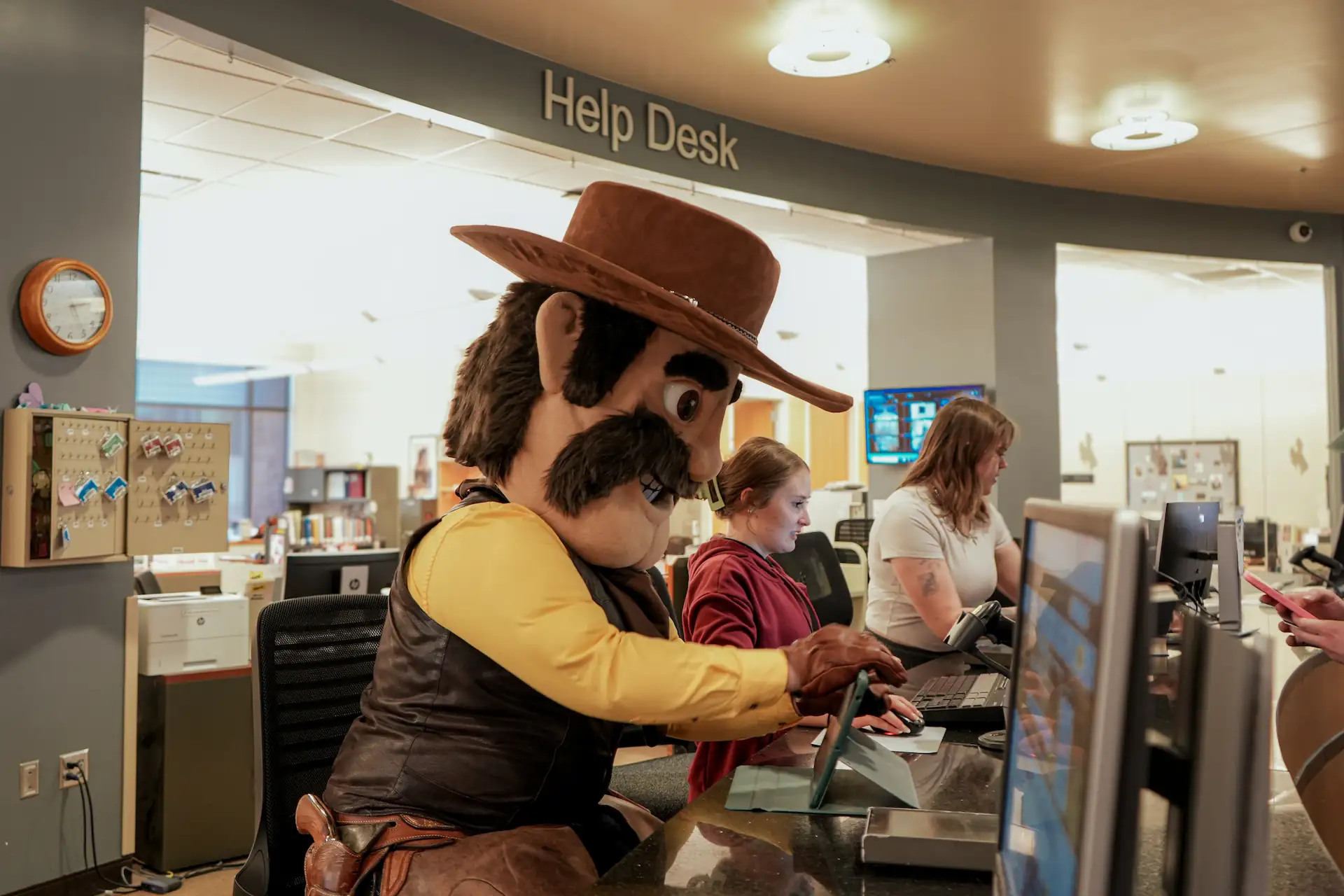 Pistol Pete mascot using a tablet at the University of Wyoming Libraries Help Desk