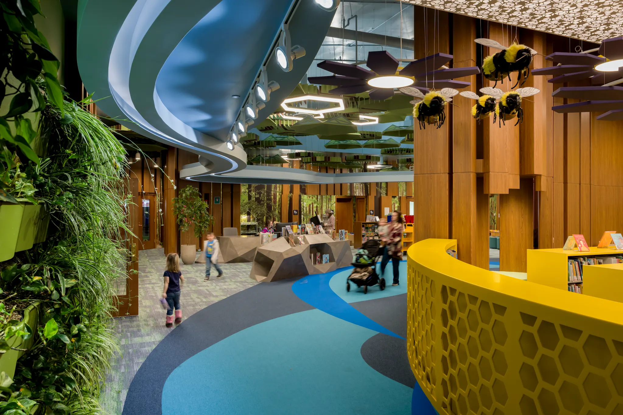 Building Minds: Designing Learning Spaces for Connection and Coherence 3 Children's area at Redford Township District Library with colorful design, plants, and bee decorations.