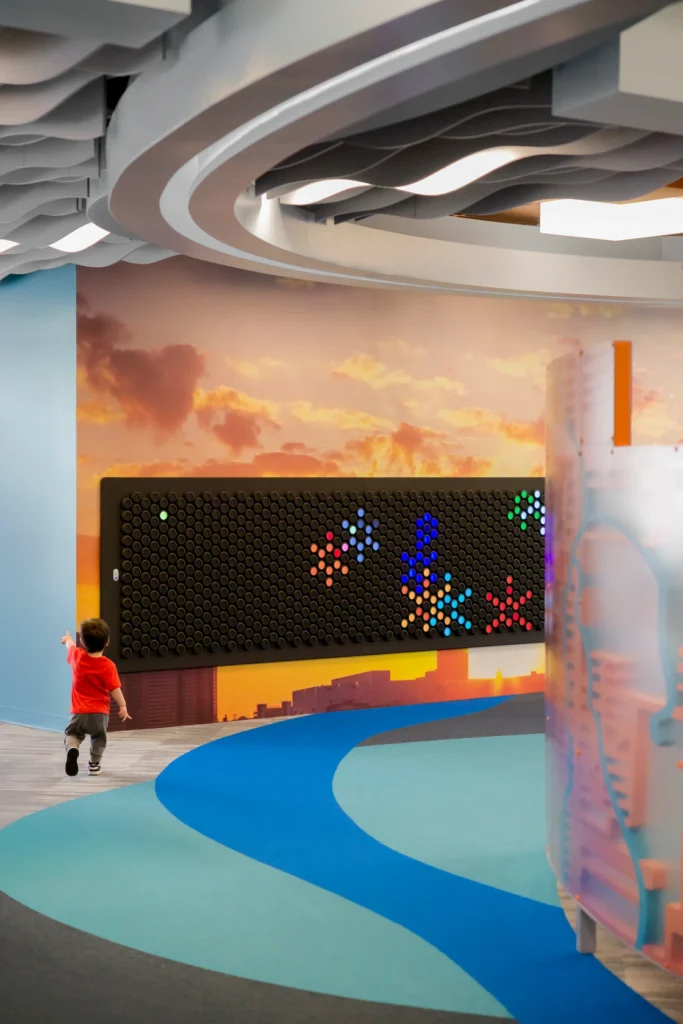 selfCheck + integrated return bins for service-centric success: Redford Township District Library 7 Children's reading nooks with floral mural at Redford Township District Library.