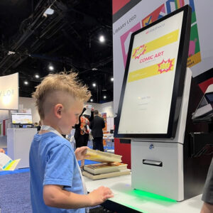 Solutions 21 selfCheck 3000 being used at an event by a young boy