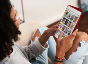 woman reading magazine on tablet 2 | Webinar: Reimagining library access when it’s needed most