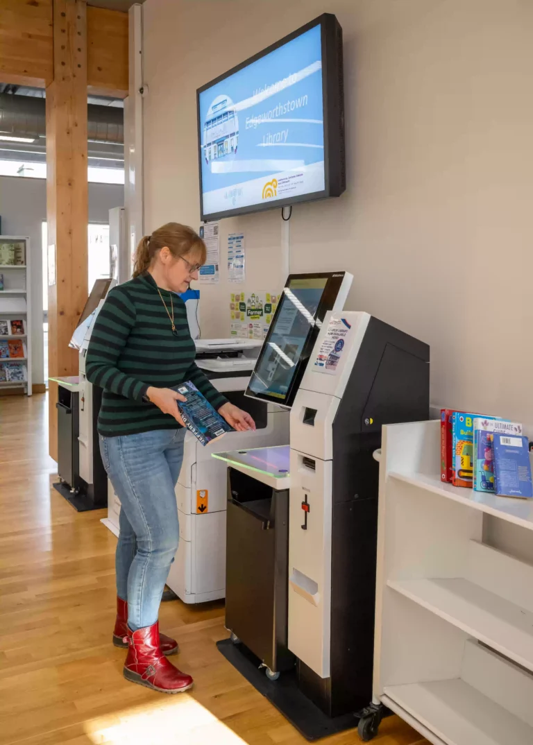 Extending Access, Strengthening Community: The Edgeworthstown Library Story 5 Library member using a Bibliotheca self-service kiosk at Edgeworthstown Library, County Longford, Ireland, to borrow and manage library items independently.